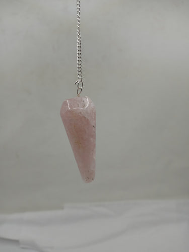 A stunning rose quartz rounded pendulum elegantly hangs from a silver chain on a serene white background.