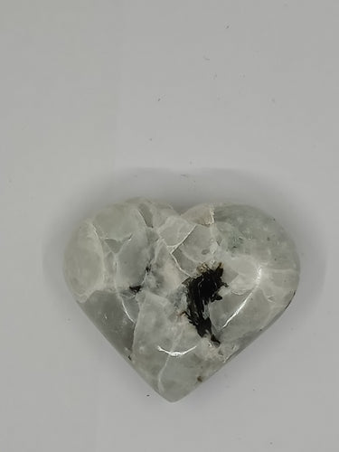 Heart-shaped Rainbow Moonstone Puffy Heart Stone with black and white pattern.