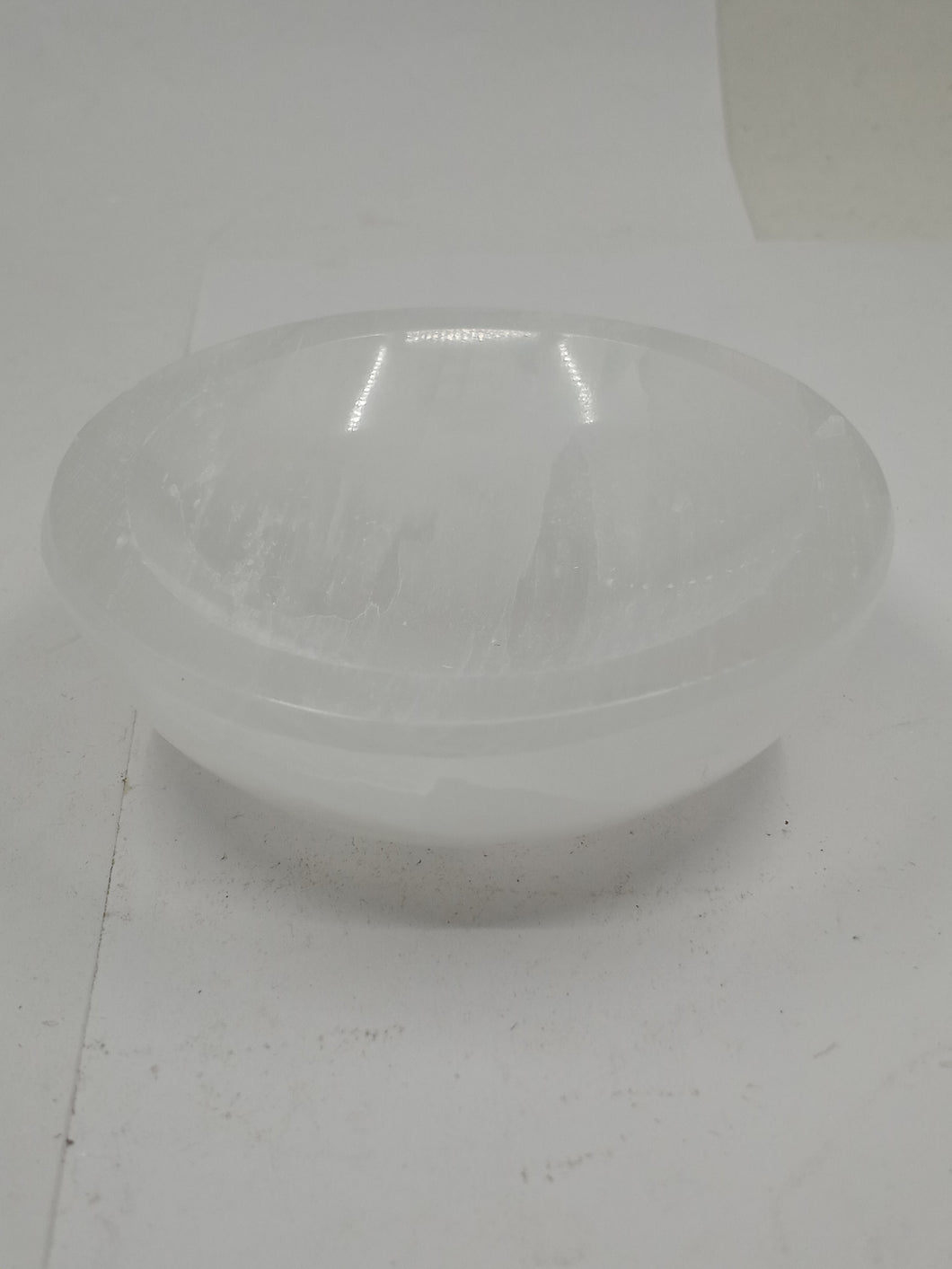  A clear Selenite Bowl placed on a white background.