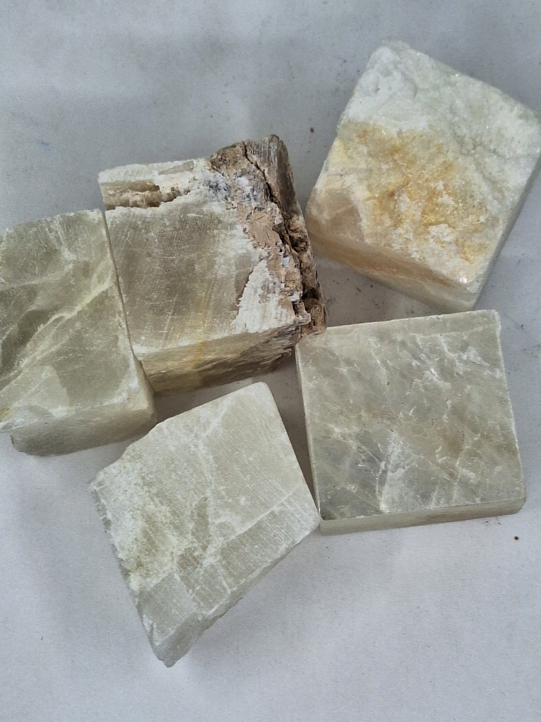 A collection of Brazilian selenite translucent cube chip stones healing crystal that promotes peace and calm.