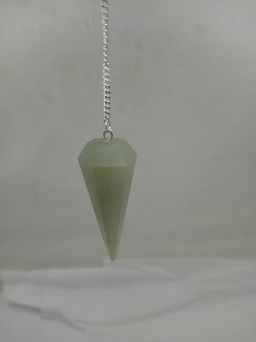 A green aventurine faceted pendulum elegantly hangs from a silver chain on a serene white background.