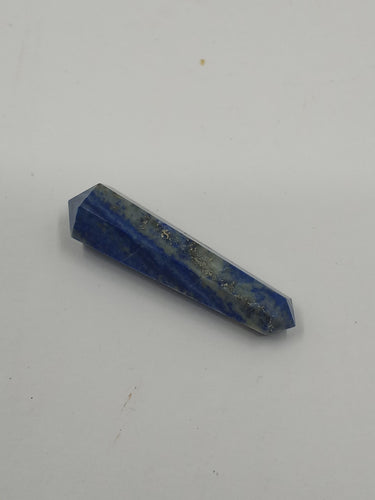 A beautiful lapis lazuli double terminated point pencil 45-50mm on a serene white background.