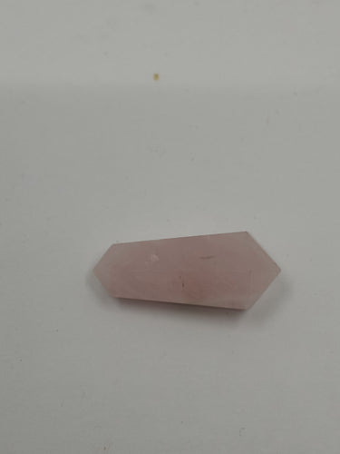 A beautiful rose quartz petit point double terminated on a serene white background.
