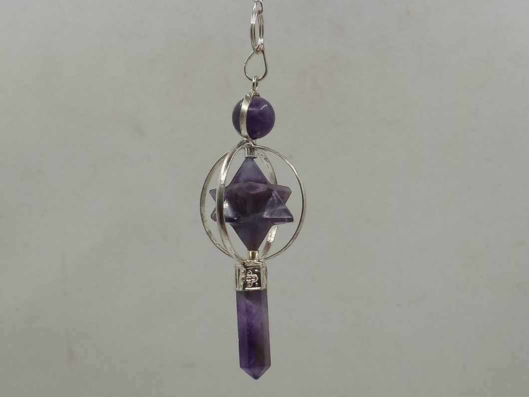 Crafted from amethyst crystals, the three-piece Merkabah pendulum features a geometric form with two interlocking tetrahedrons.