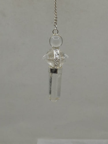 A beautiful quartz 3 pc hexagonal pendulum elegantly hangs from a silver chain on a serene white background.