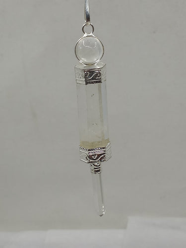 A beautiful clear quartz 3 pc pendulum wand on a serene white background.
