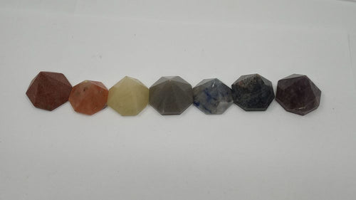 A set of seven chakra pyramids of octagon shape with seven different colors.
