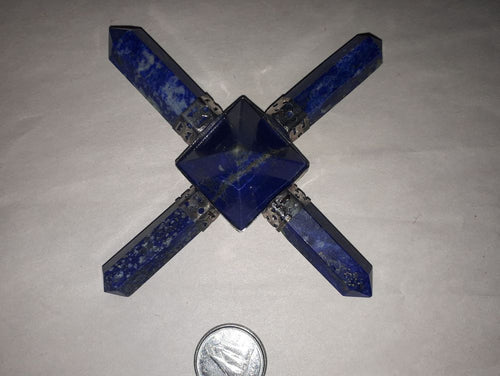 A lapis lazuli points aura generator tool in blue with a coin on a serene white surface.