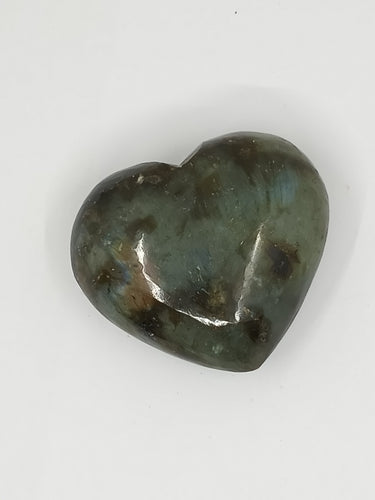 A heart-shaped labradorite puffy stone with green and black spots.