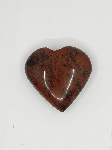 The heart-shaped obsidian mahogany puffy stone with black and red spots on a white background.