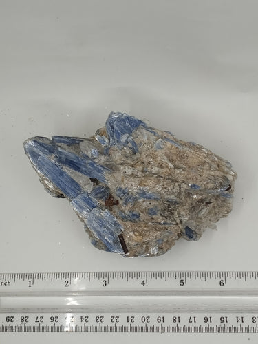 A rare kyanite stone, with streaky gray and white pattern on serene white surface.