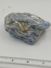 Load image into Gallery viewer, A kyanite stones with varying shapes with a streaky blue color with some hints of gray and white.
