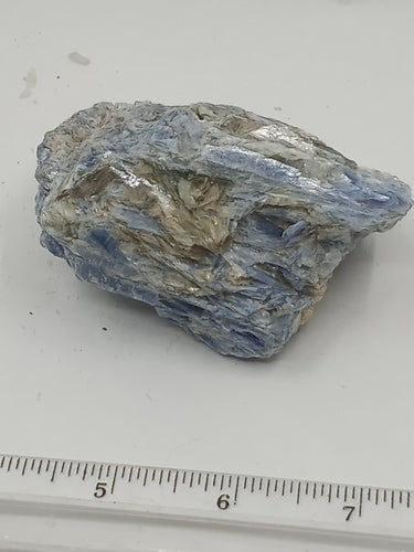 A kyanite stones with varying shapes with a streaky blue color with some hints of gray and white.
