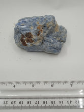 Load image into Gallery viewer, A kyanite stones in blue hues with streaks of gray and white, unique shapes on a serene white surface.
